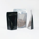Load image into Gallery viewer, Clear/Foil/Black Stand Up Pouches With Resealable Zip &amp; Tear Notch - Titan Packaging
